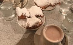 A table with Beignets and coffee at Cafe Du Monde