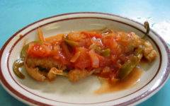 Chile pod with puffy fried coat is smothered with hot salsa