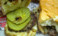 A single slider, dressed with pickle chips