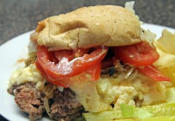 Steamed cheeseburger with lettuce, and tomato in a bun ...