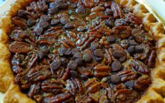 Dark, syrup-sweet pecan pie is further sweetened by a crowd of chocolate chips (and, not seen, bourbon).