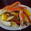 Crab legs top a Lowcountry boil of shrimp, potatoes, corn and sausage