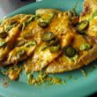 Nachos made with puffy tortilla chips and topped with sliced jalapenos