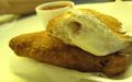 The deep fried calzone at Pizza Town USA with a side of sauce