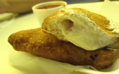 The deep fried calzone at Pizza Town USA with a side of sauce