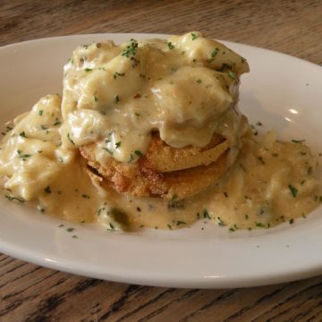 Big, pearly hunks of crab imperial swaddled in creamy sauce, perch atop a short stack of crisp-fried green tomatoes.