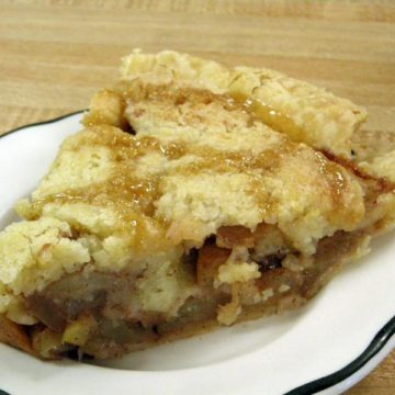 Apple pie is topped with a crust ribboned with streaks of caramel