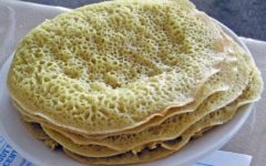 Countless little holes in a stack of wafer-thin yellow ployes beg to sop up butter.