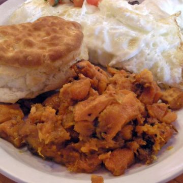 Hash browns made of sweet otatoes are accompanied by a biscuit and an egg white omelet