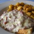 Creamed chipped beef on toast, potatoes at the back of the plate