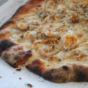 Char-crusted pizza speckled with clams, garlic, and herbs