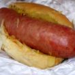 Extra-plump sausage, ready to burst with juice, overloads a standard-size hot dog bun