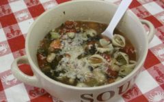 Multi-vegetable minestrone soup topped with shredded asiago cheese