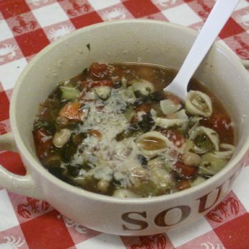 Multi-vegetable minestrone soup topped with shredded asiago cheese