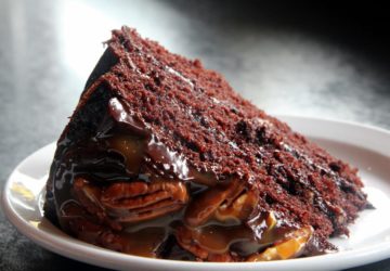 Chocolate layer cake frosted with caramel and pecans