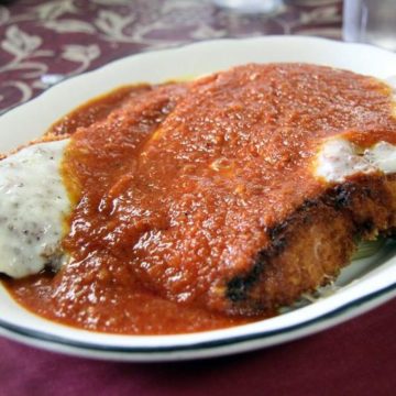 Crisp-crusted fried chicken cutlet is blanketed with cheese and spicy red sauce at Mike's Kitchen in Cranston, RI