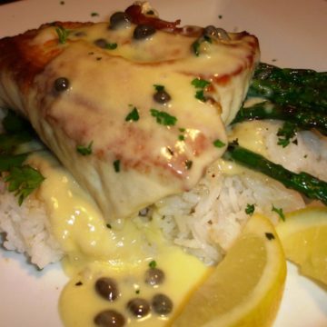 A thick halibut steak glazed with butter/caper sauce comes with jasmine rice and vegetables.