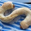 Crisp, flaky, sweet puff pastry the size of a plate, forms the letter "S"