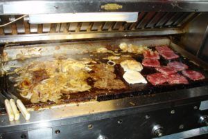 The grill filled with philly cheesesteaks at Donkey's Place