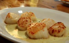 A plate of silk-smooth broiled scallops in a puddle of lemon-caper butter