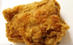 Fried chicken thigh enveloped in crunchy golden crust