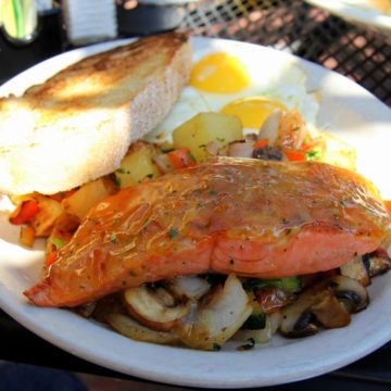 Sockeye salmon drizzled with marmalade atop sauteed vegetables, with sourdough toast and eggs