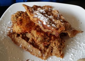 A plate of waffles and fried chicken at Dame's Chicken & Waffles in Durham, NC