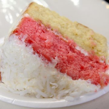 2-layer cake, strawberry atop coconut cake with plenty of coconut frosting