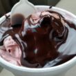 Silky hot fudge tops pink cherry ice cream.