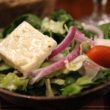 Feta cheese crowns tangy Greek salad.