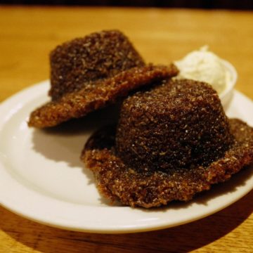 Plate holds two dark bran muffins, infused with honey