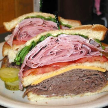 Cross-section of a double-decker sandwich: ham on top, roast beef and cheese below