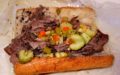 Gravy-sopped Italian beef piled into a length of bread with spicy vegetable giardiniera