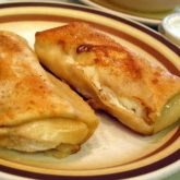 Cheese is ready to ooze out of a pair of buttery cheese blintzes
