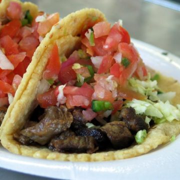 Soft, folded-over corn tortilla holds grilled beef, salsa and lettuce