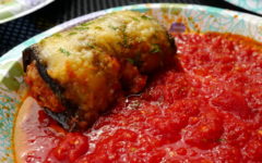 Eggplant baked around seasoned veal, topped with melted cheese, in a pool of fruity tomato sauce