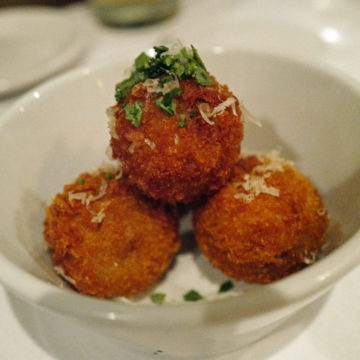 Bowl of crisp-skinned spheres of fried rice balls