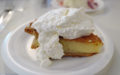 Ethereal yellow buttermilk pie is heaped with fresh whipped cream