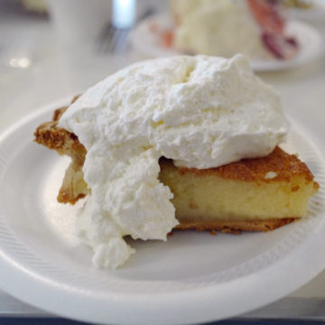 Ethereal yellow buttermilk pie is heaped with fresh whipped cream