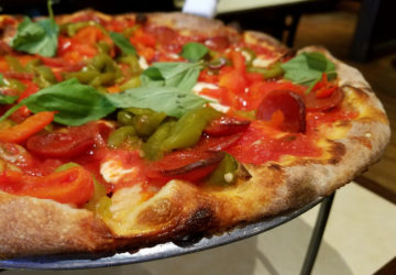 Crisp/chewy crust supports peppery pepperoni, roasted red and green peppers, buttery mozzarella, and fresh basil.