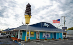 A chocolate-sheathed ice cream cone and the American flag fly over the Zesto drive-in