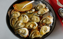 Baked oysters topped with Parmesan cheese