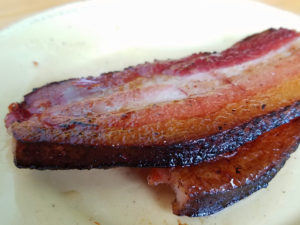 A strip of pork belly is striated like bacon, but thicker and even more succulent