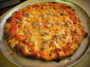 Sausage pizza with slight char on its crust