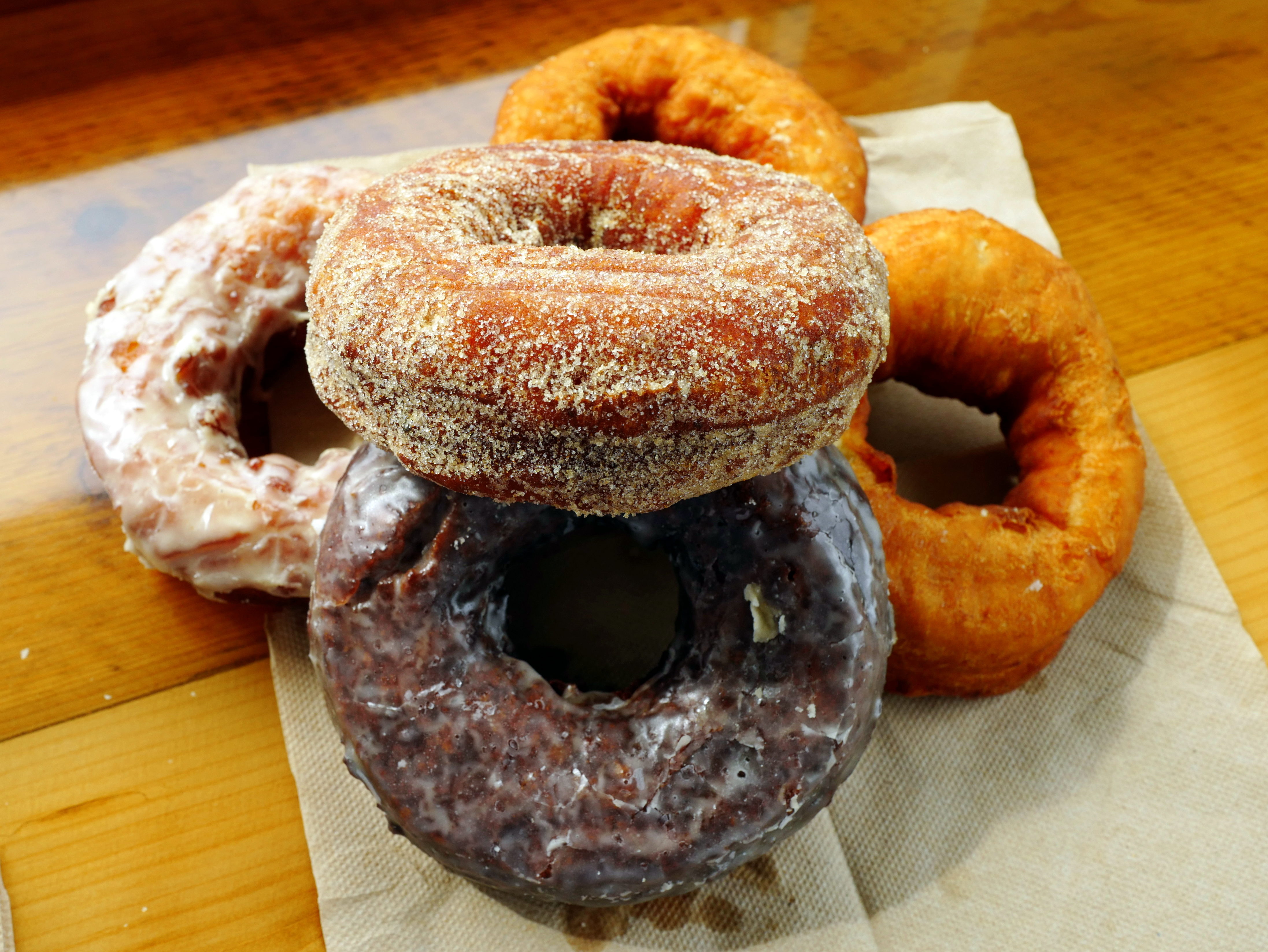 a pile of donuts at Holy Donut