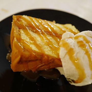 Caramel-iced cake and ice cream drizzled with caramel sauce