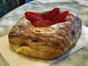 Strawberries atop a croissant at Porto's Bakery and Cafe