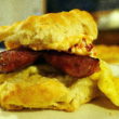 A knobby breakfast biscuit sandwiches sausage, eggs, and pimento cheese