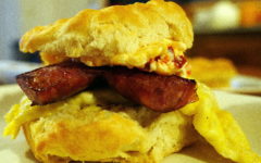 A knobby breakfast biscuit sandwiches sausage, eggs, and pimento cheese