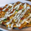 Jalapeno sour cream is drizzled across a chicken yam frittata